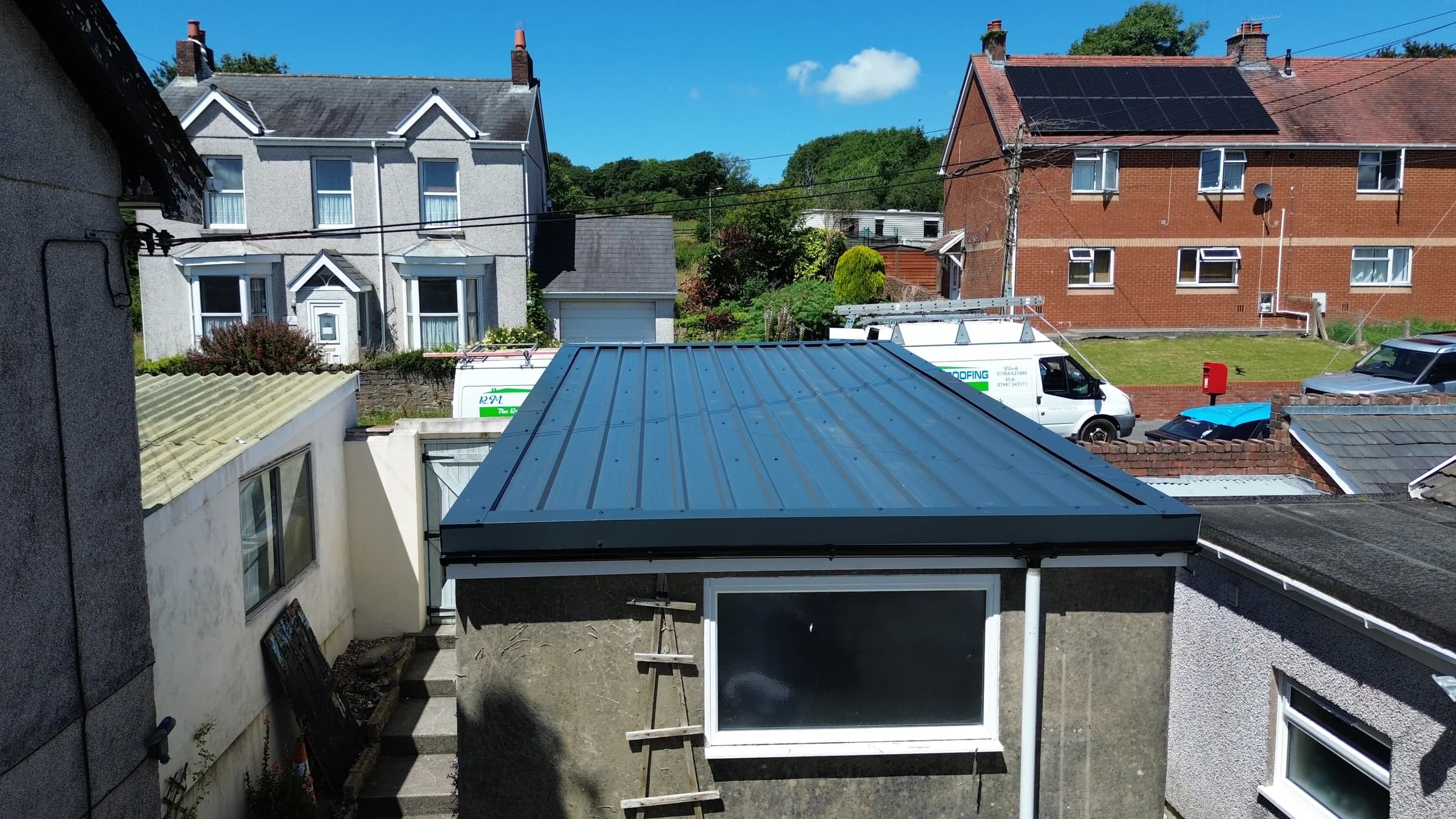 Completed standing seam metal roof on a sunny day, South Wales