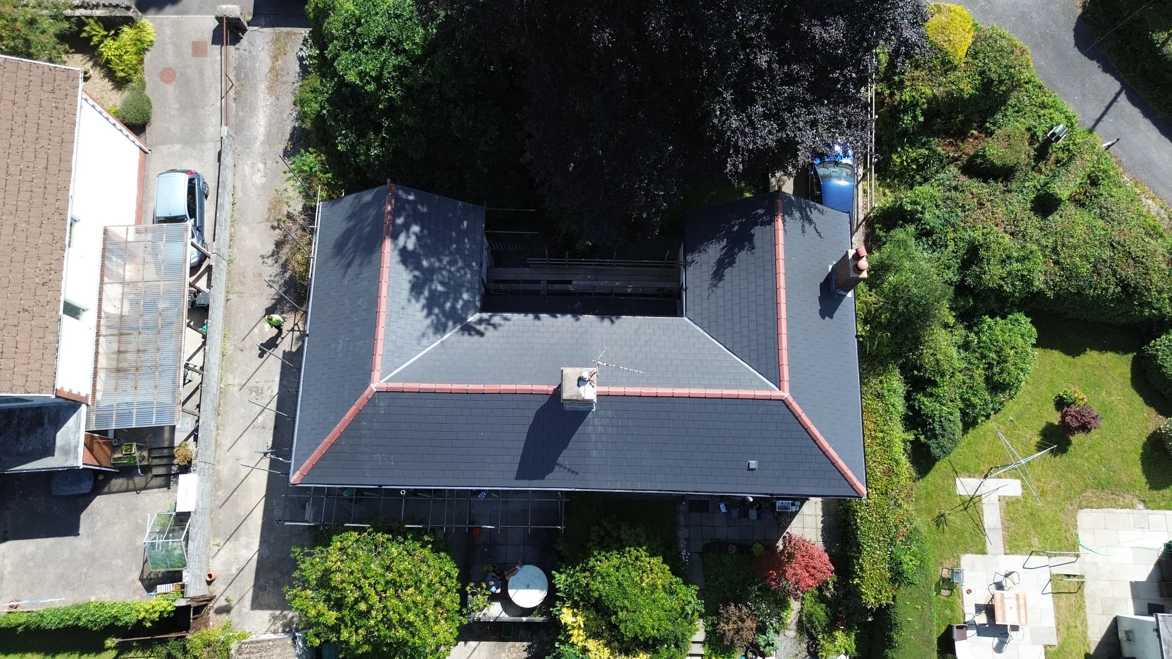 New slate roof with red ridge tiles, overhead aerial view, Neath